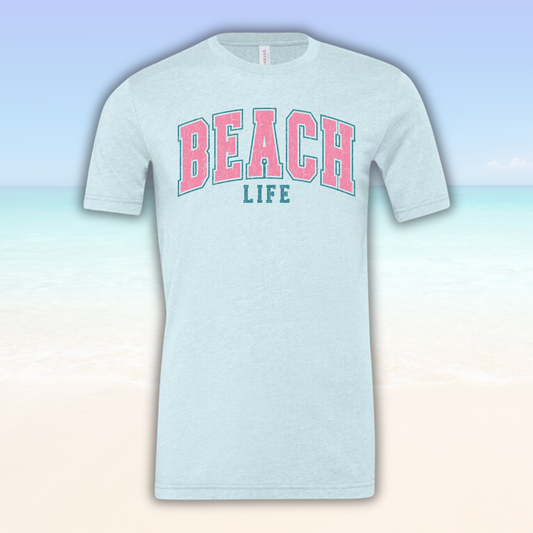 Beach Life Vibe Tee with pink lettering on a soft blue fabric.
