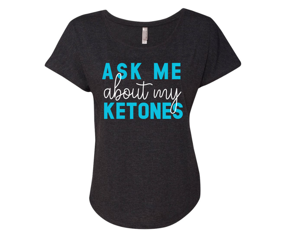 Black shirt with "Ask Me About My Ketones" text in blue and white.