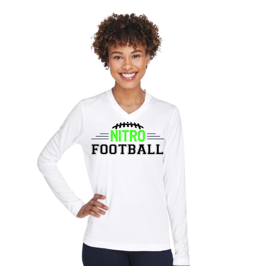 Woman wearing white Long Sleeve Nitro Football t-shirt with green and black text, smiling and standing with hand on hip