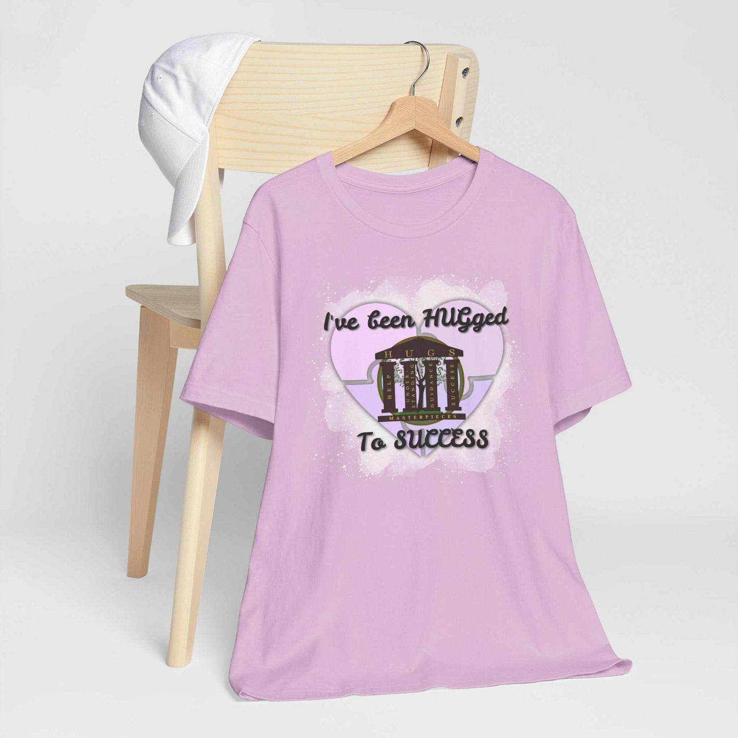 Hugged To Success Tee with vintage storefront and pastel heart design on pale blush breathable cotton shirt