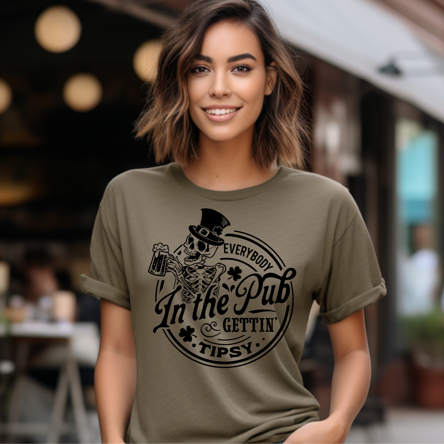 Tipsy Shirt with playful design worn by smiling woman outdoors.