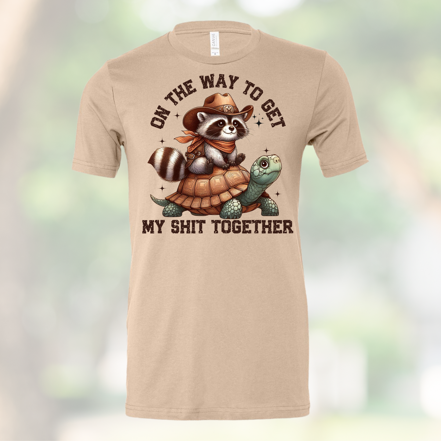 Unisex "On my Way to Get My Shit Together" motivational shirt with raccoon and turtle design.