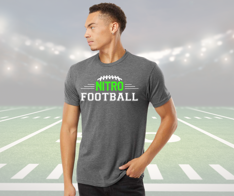 Adult unisex Nitro Shirt in gray with football design and text on front, worn by male model on football field background