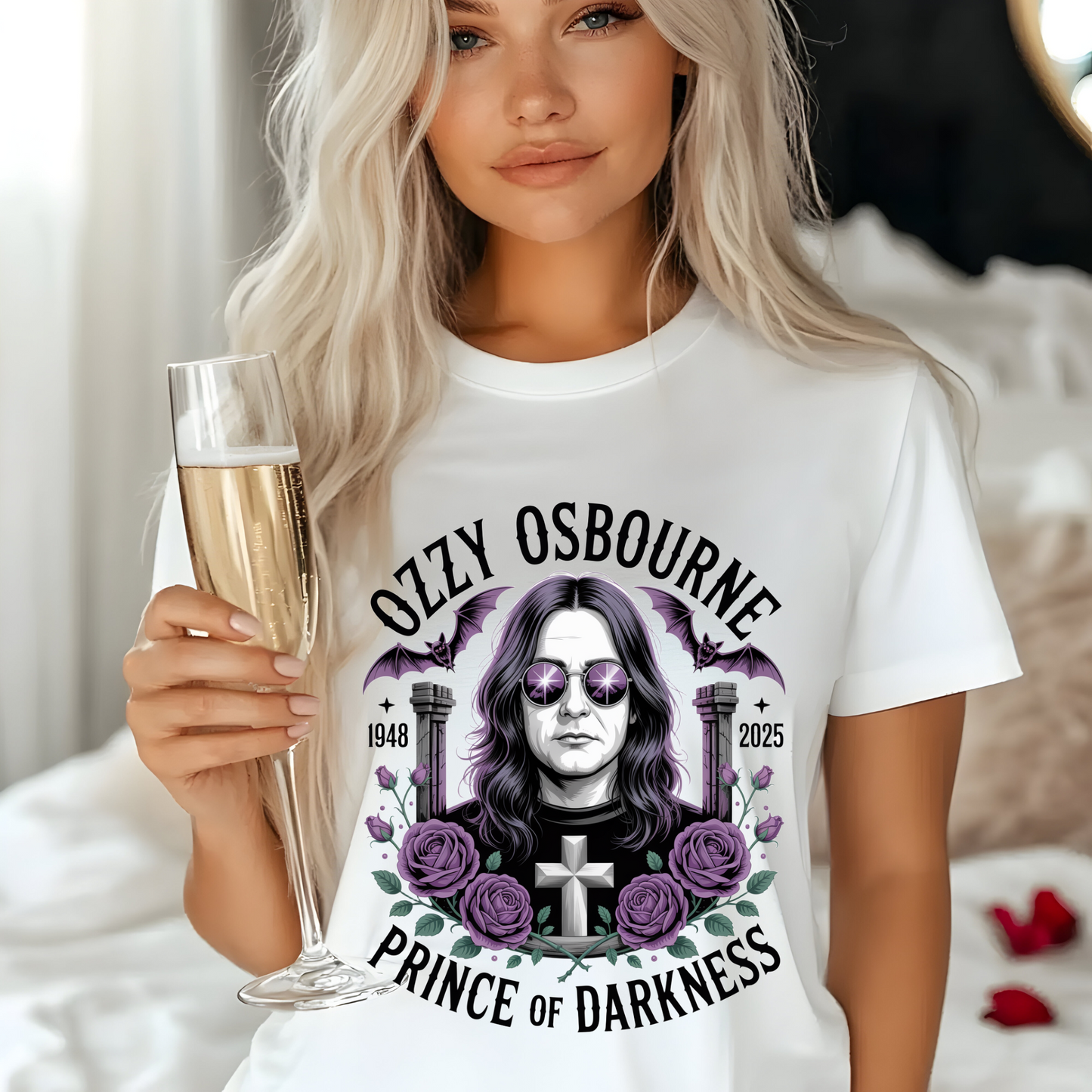 Woman wearing white Ozzy Osbourne Prince of Darkness shirt with graphic design holding a glass of champagne