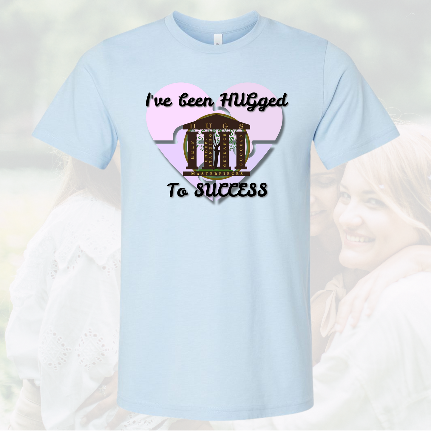 Light blue crew neck t-shirt with "I've Been HUGged To SUCCESS" text and heart graphic design