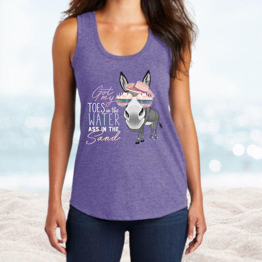 Woman wearing purple Vacation Toes in the Water Ass in the Sand tank top with donkey graphic on beach background