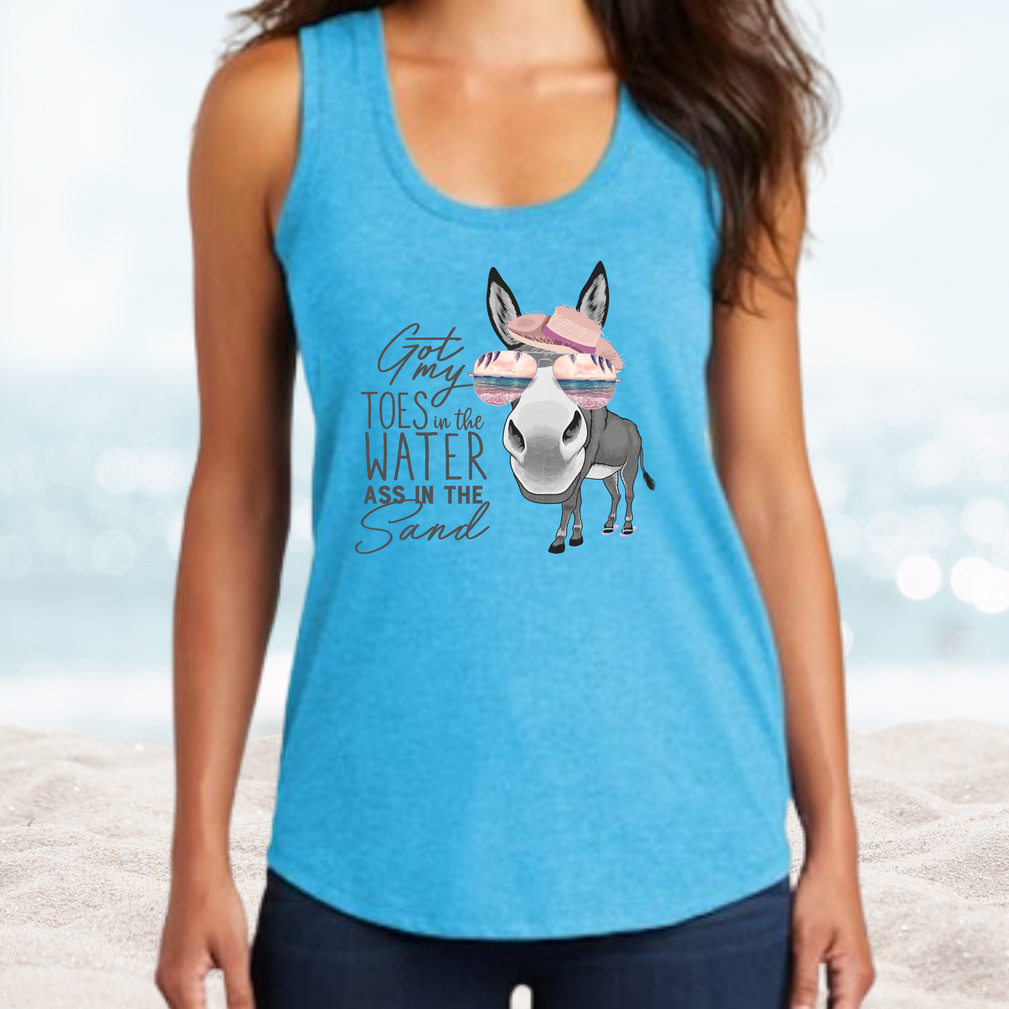 Women's blue Vacation Toes in the Water tank top with a donkey wearing sunglasses and hat design on the beach background