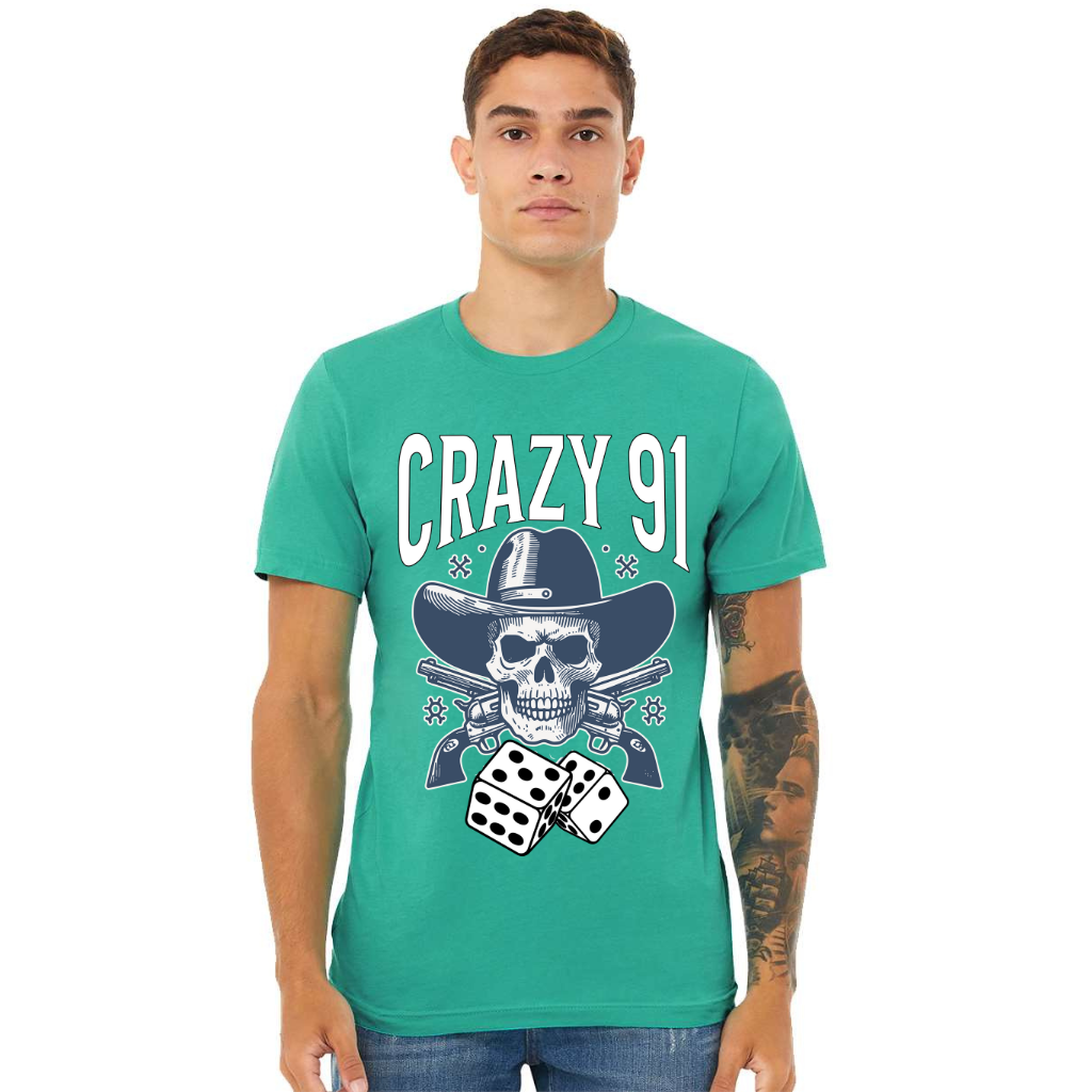 Man wearing vibrant teal Crazy 91 Tee with skull, guns, and dice graphic design