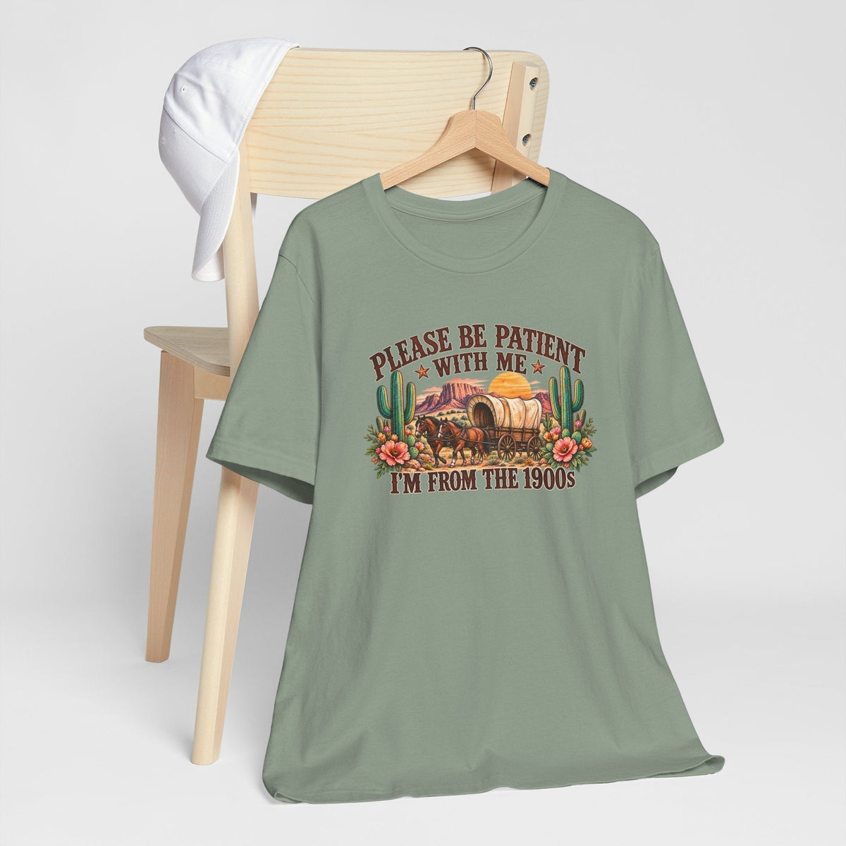cowgirl graphic tshirt in muted sage green with a vintage wagon, cactus, flowers and humorous 1900s text