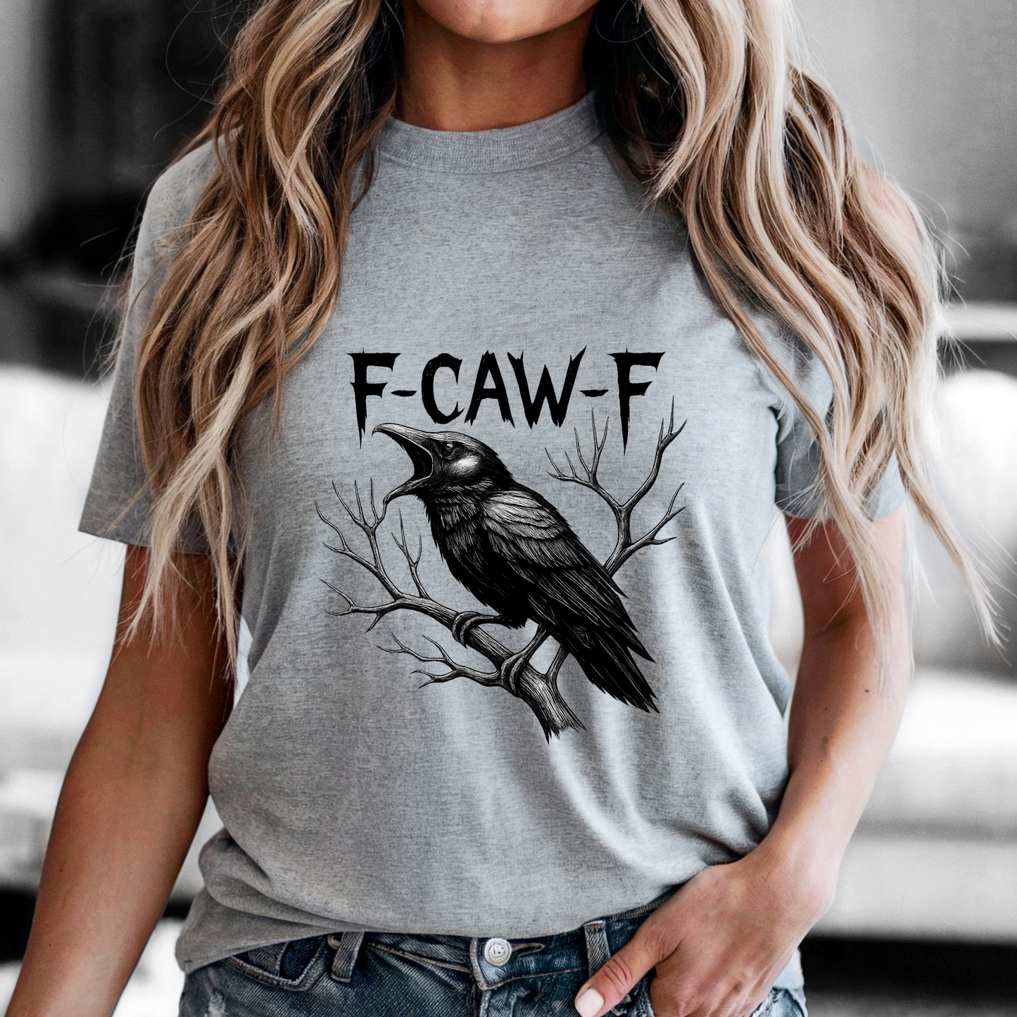 Person wearing a gray t-shirt with a black crow graphic and 'F-CAW-F' text.