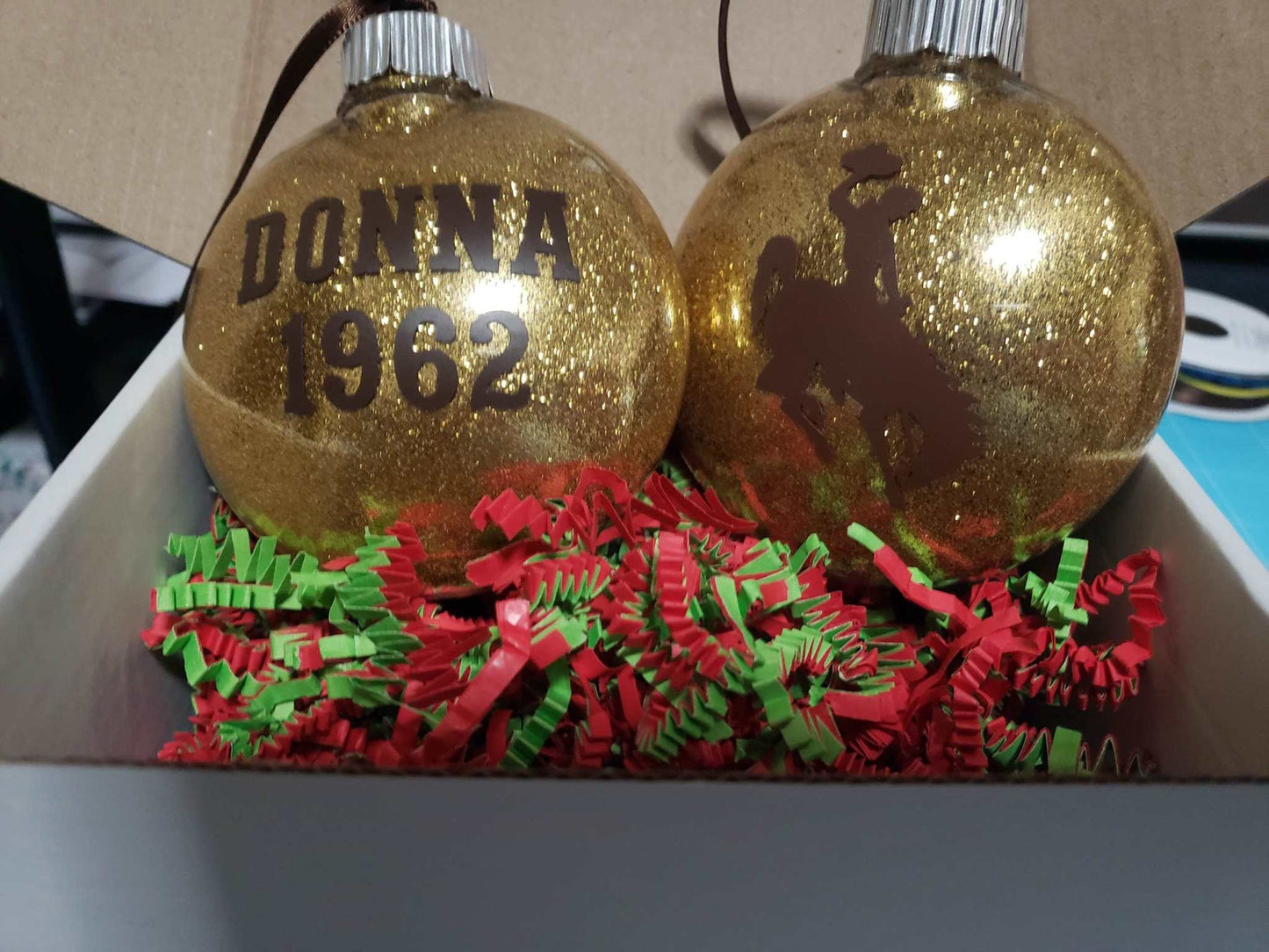 Wyoming Cowboy glitter ornament with personalized name and year, featuring University of Wyoming logo.