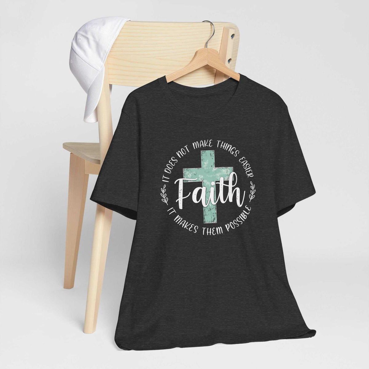 love in faith shirt in charcoal heather fabric with a distressed turquoise cross and white faith message