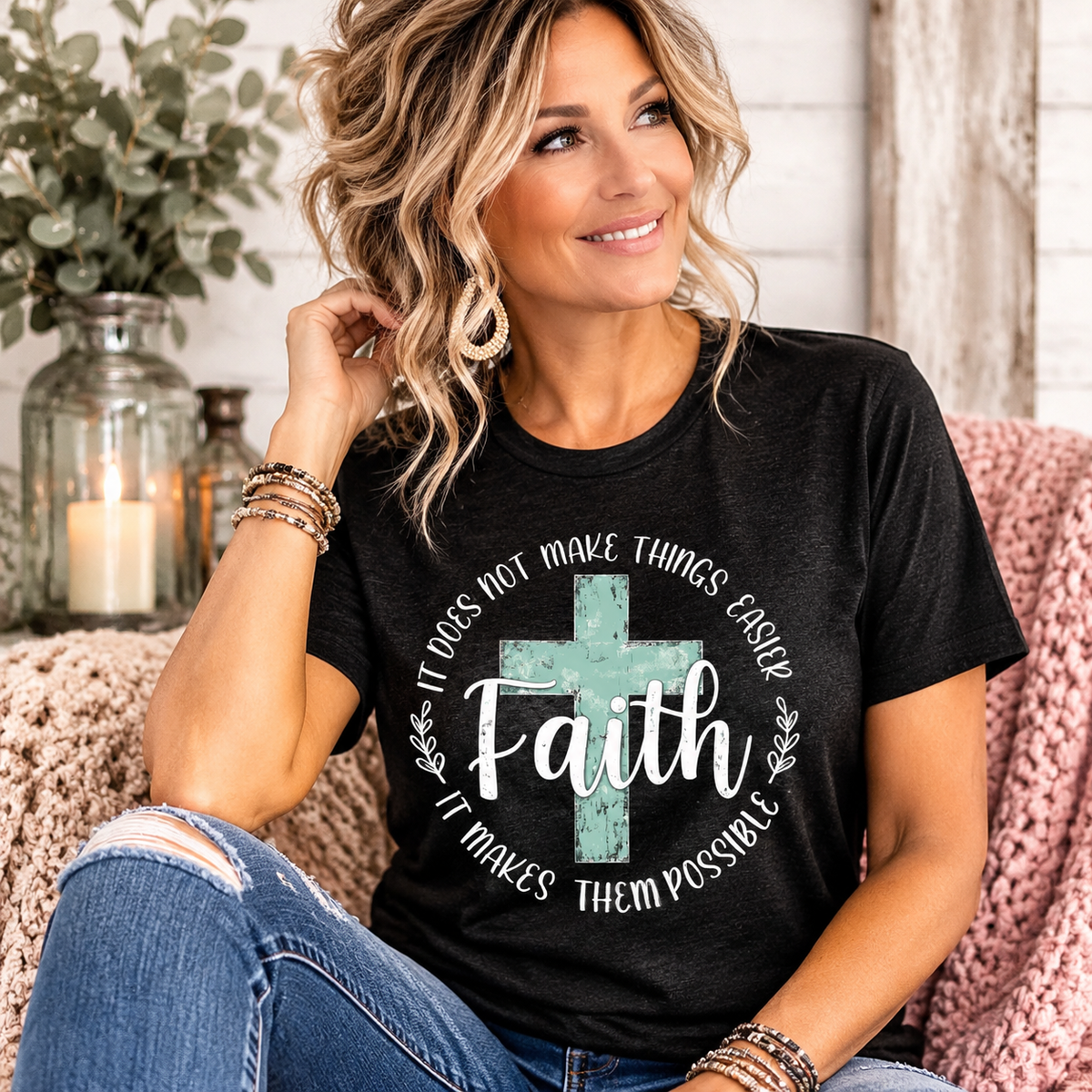 Woman wearing a black faith-based graphic tee featuring a distressed mint cross and inspirational Faith message, from Wyoming Sunset Boutique.