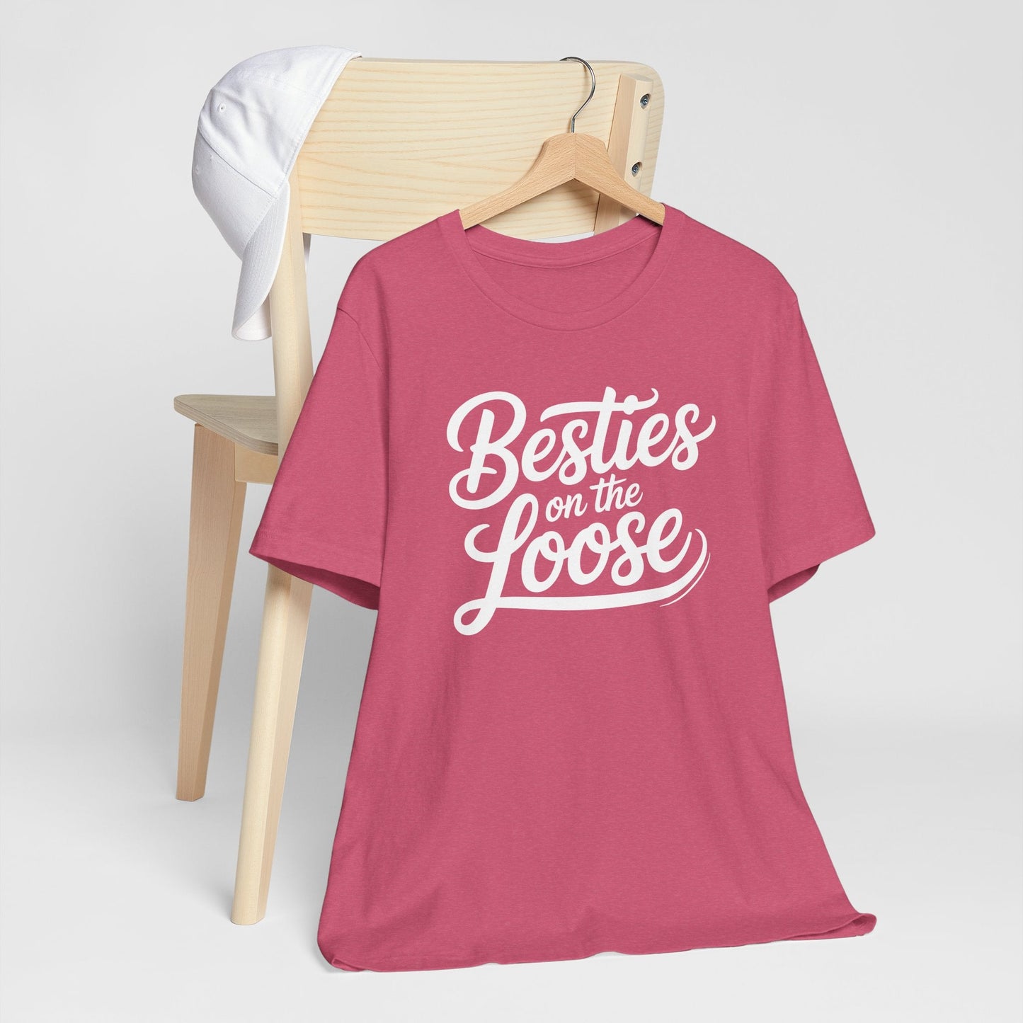 Women wearing Besties on the Loose Tee celebrating friendship outdoors