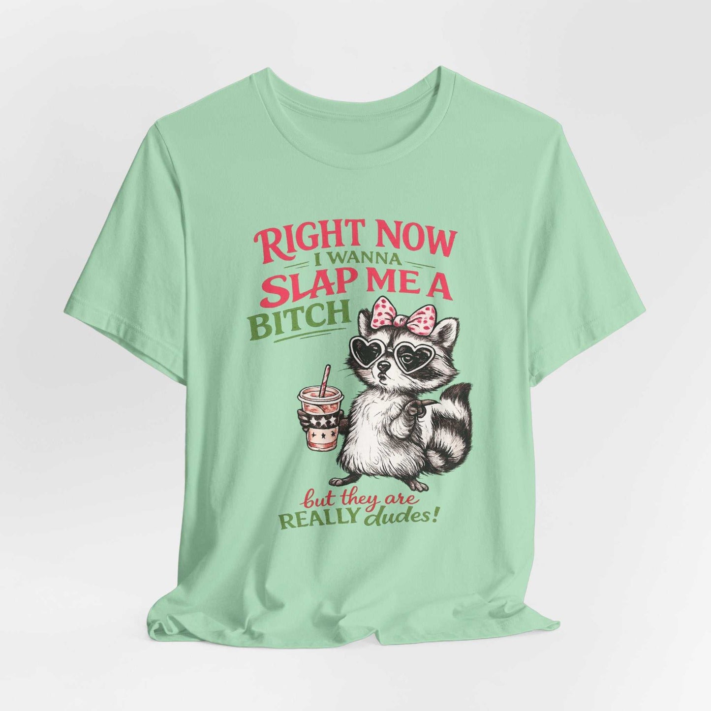 Graphic tee with sassy raccoon and "Right Now I Wanna Slap Me a BITCH" text in distressed pink and sage green lettering