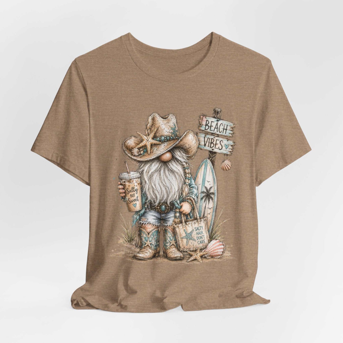 Coastal Cowgirl Beach Gnome watercolor tee with turquoise accents and cowboy boots on summer beach background