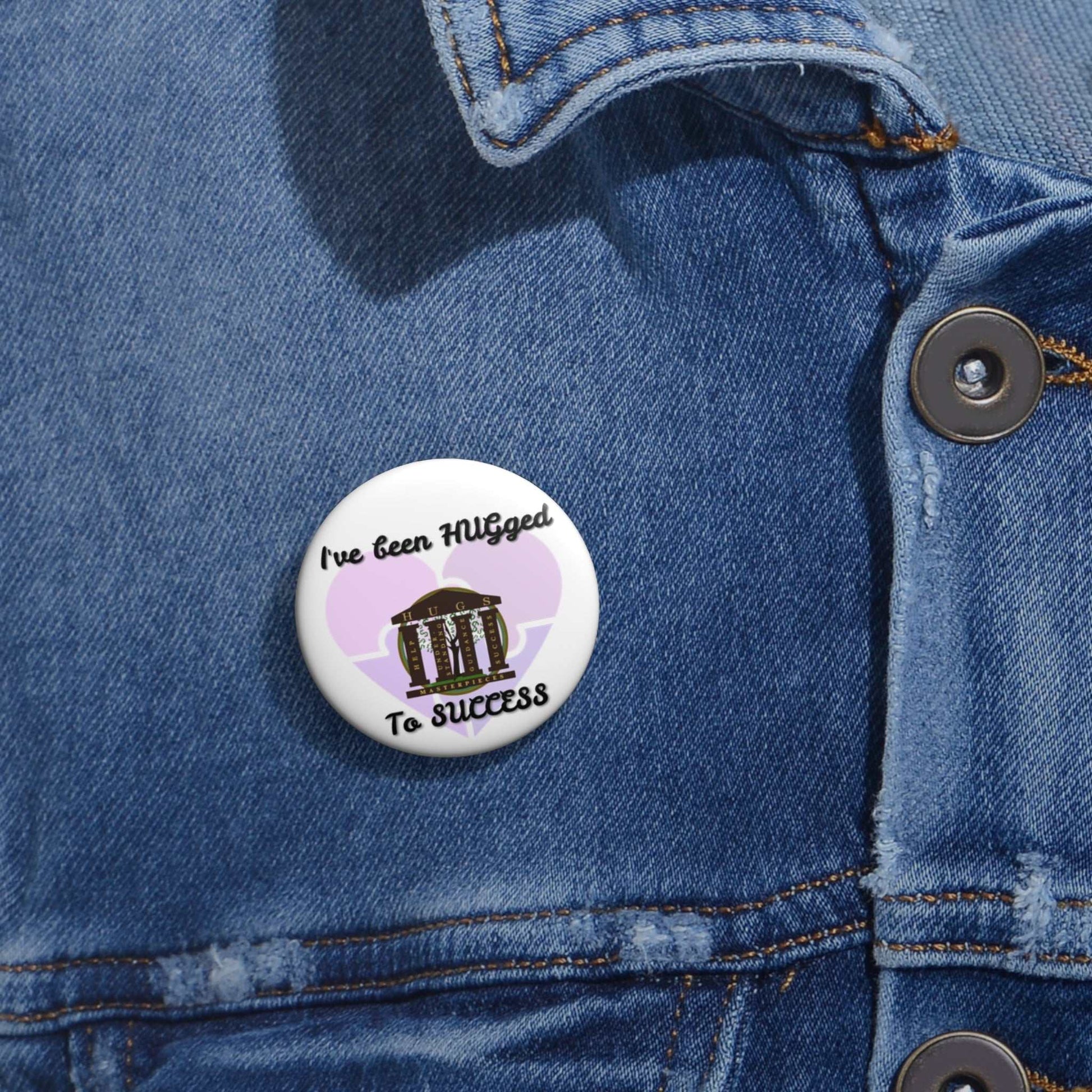 Glossy metal button pin with "I've Been HUGged to Success" inspirational design and steel safety-pin back