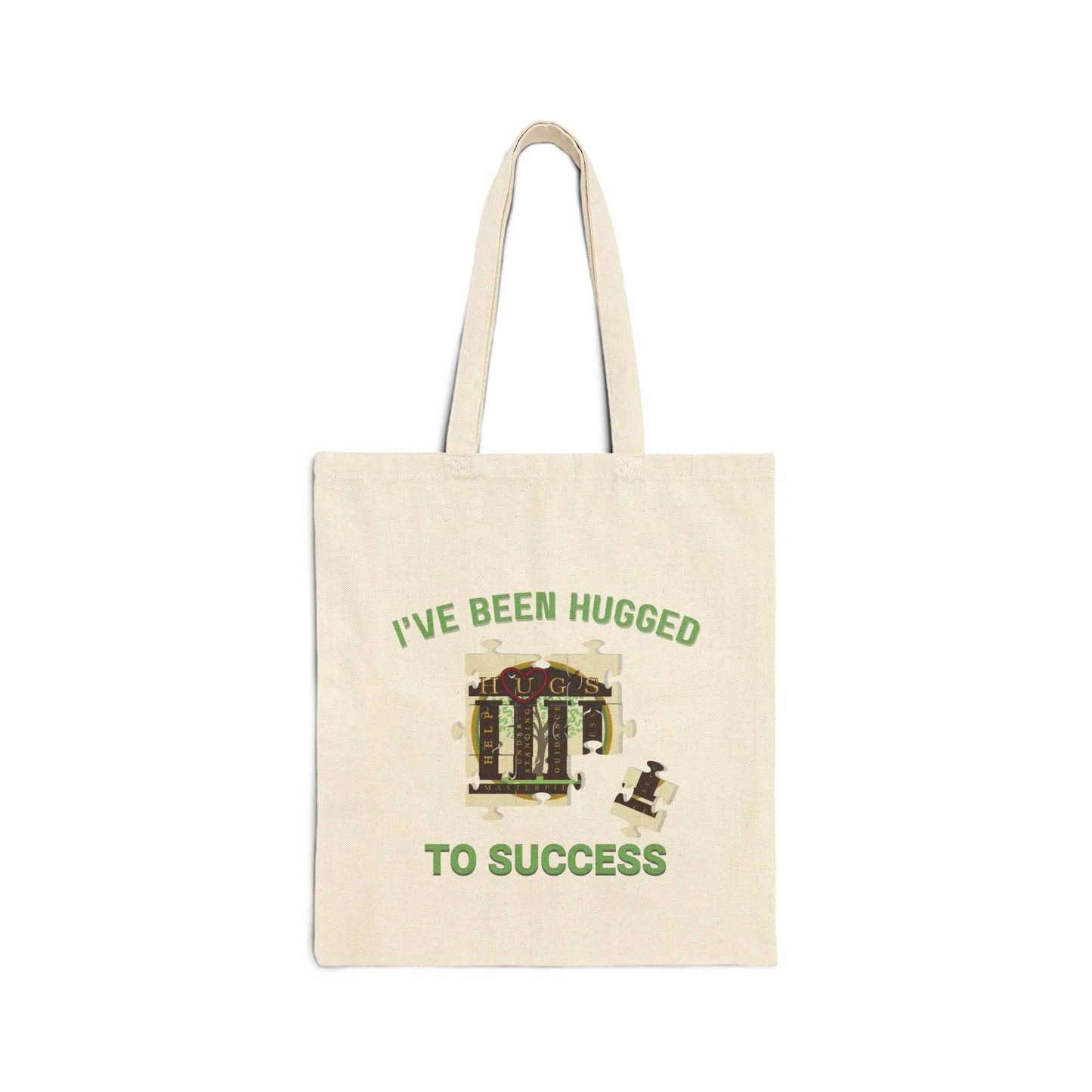 Durable cotton canvas tote bag with "I've Been Hugged to Success" design, sturdy handles, and flat-corner construction in natural color