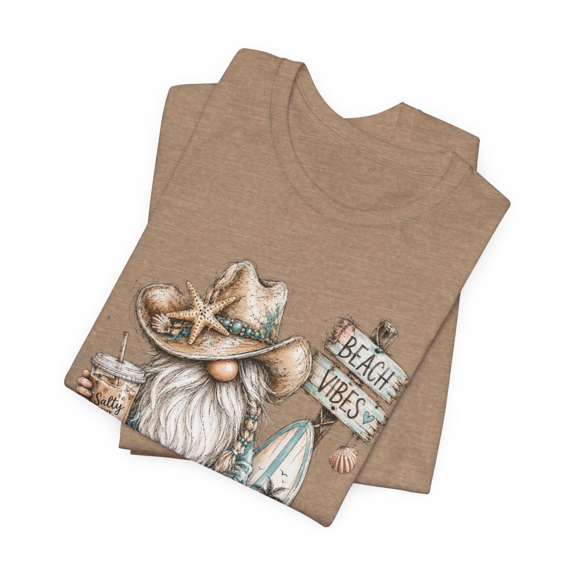 Coastal Cowgirl Beach Gnome t-shirt with turquoise accents, cowboy boots, and seashells in a whimsical watercolor style