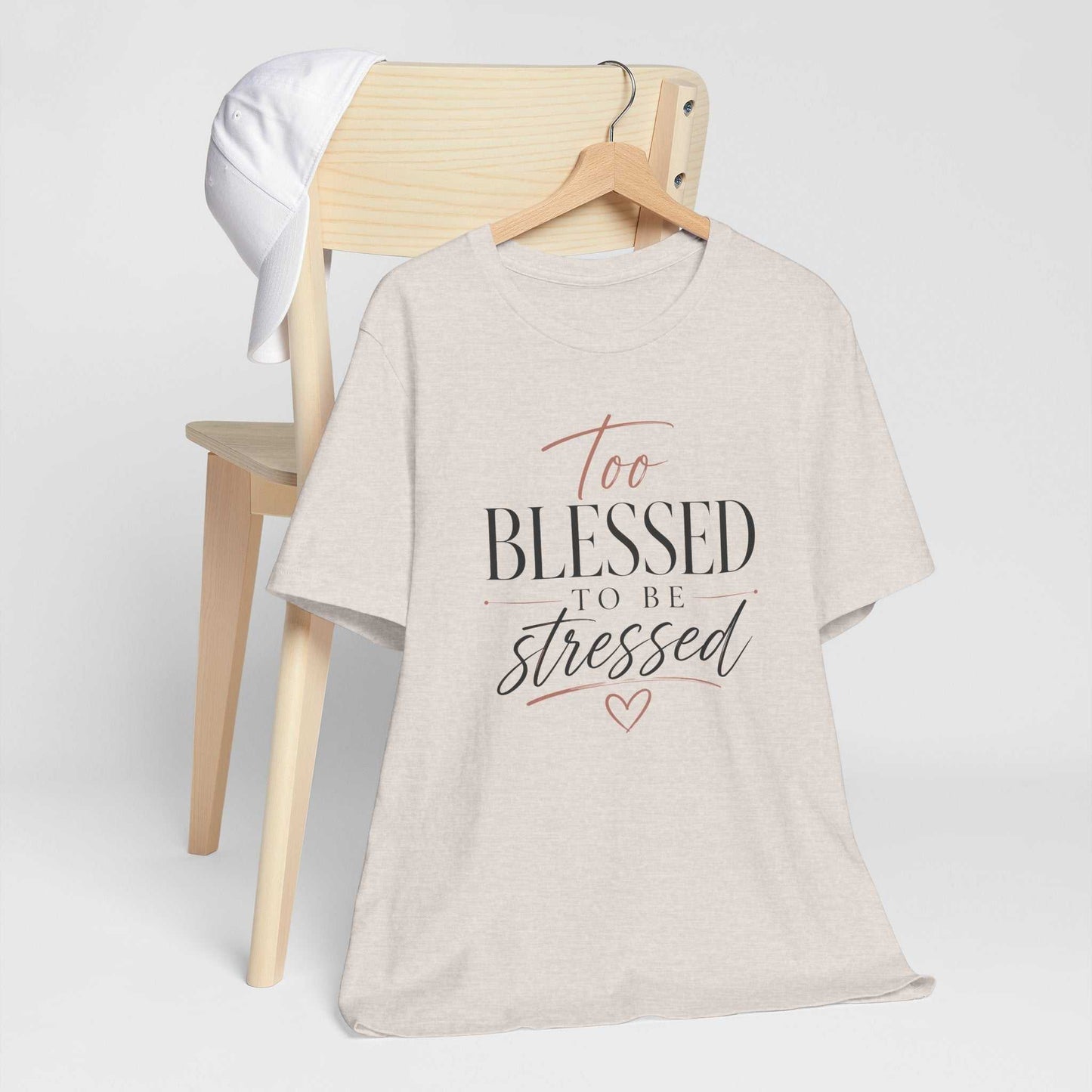Too Blessed To Be Stressed unisex jersey tee with pink script and white lettering on dark fabric, soft and comfortable inspirational graphic shirt