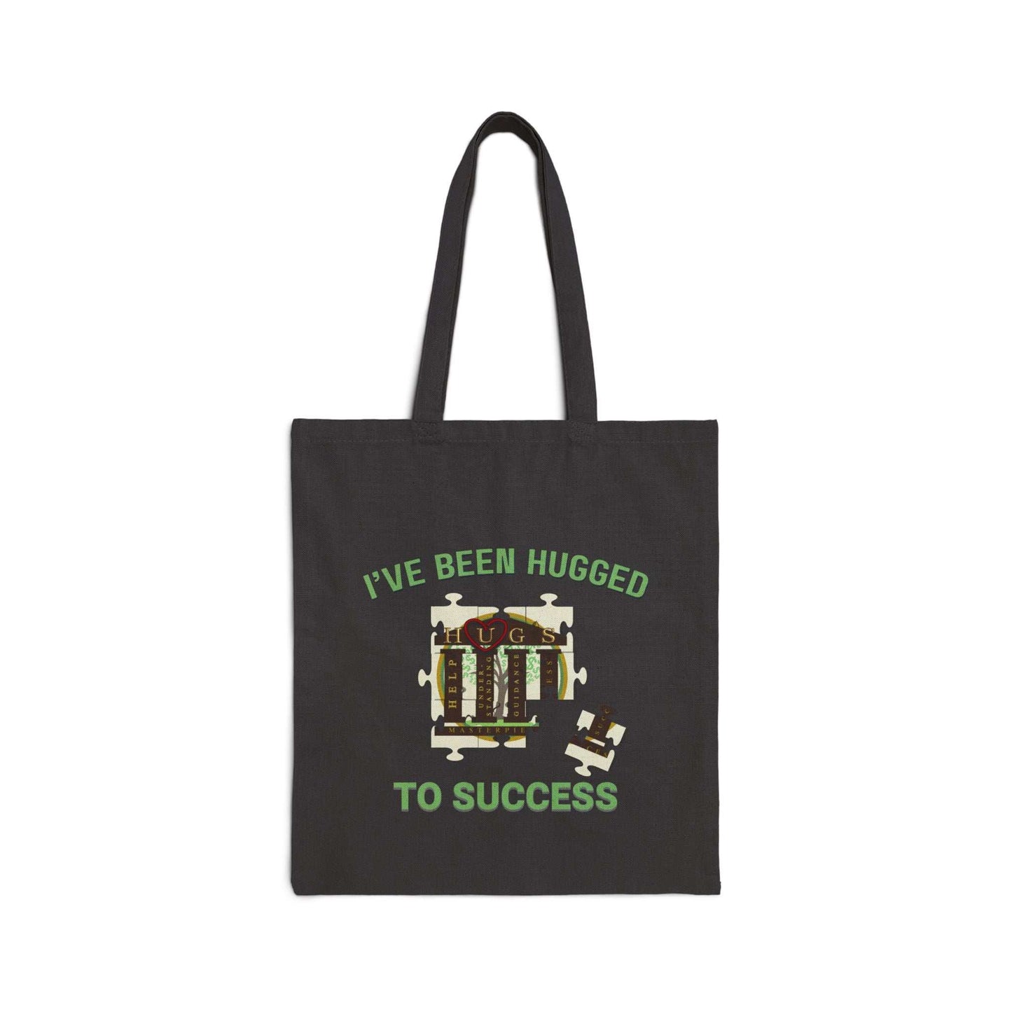 Natural cotton canvas tote bag with "I've Been Hugged to Success" print, sturdy handles, and flat-corner design.