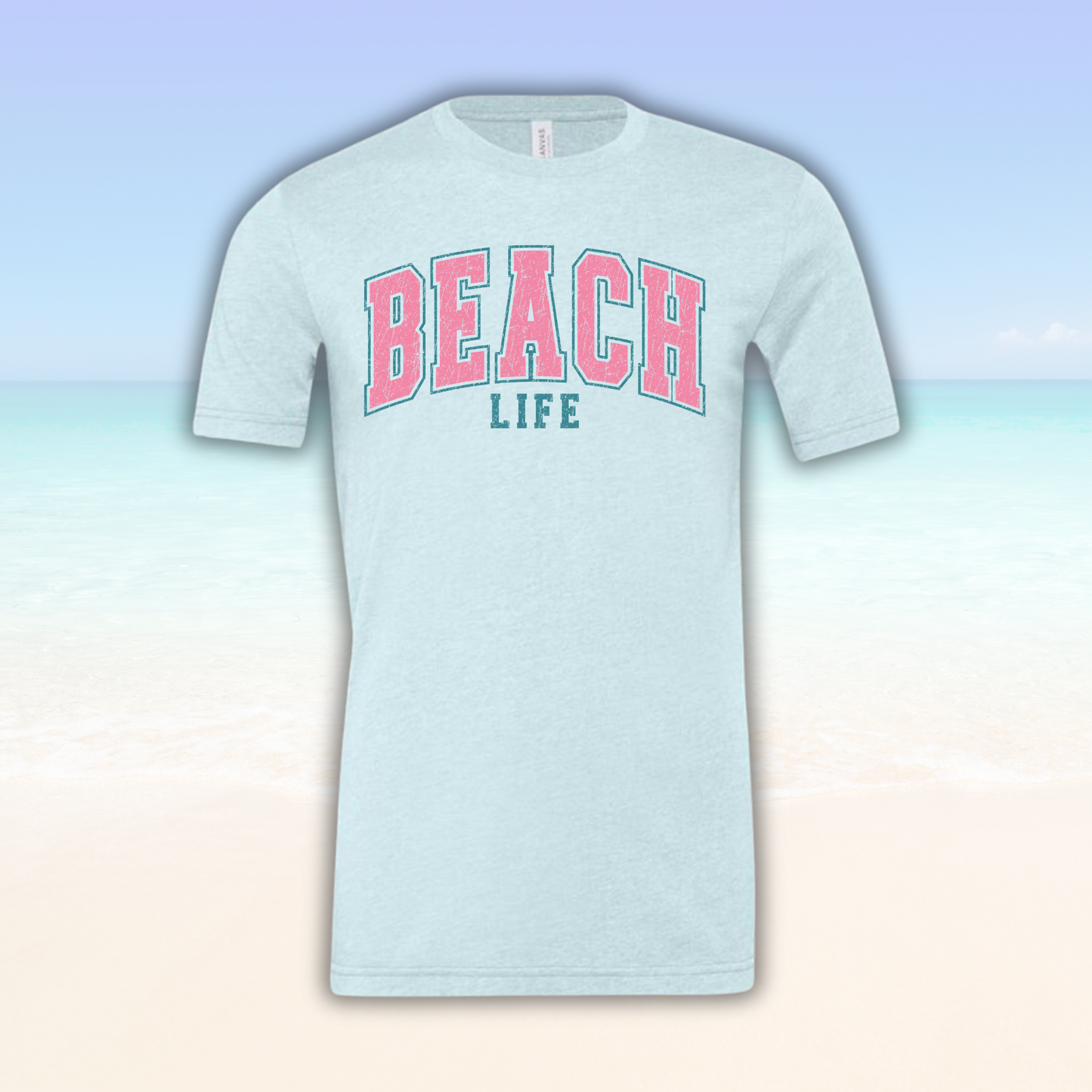Beach Life Vibe Tee with pink and green text on a soft fabric, ideal for beach days.