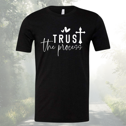 Unisex crew neck tee with "Trust The Process" design in black.