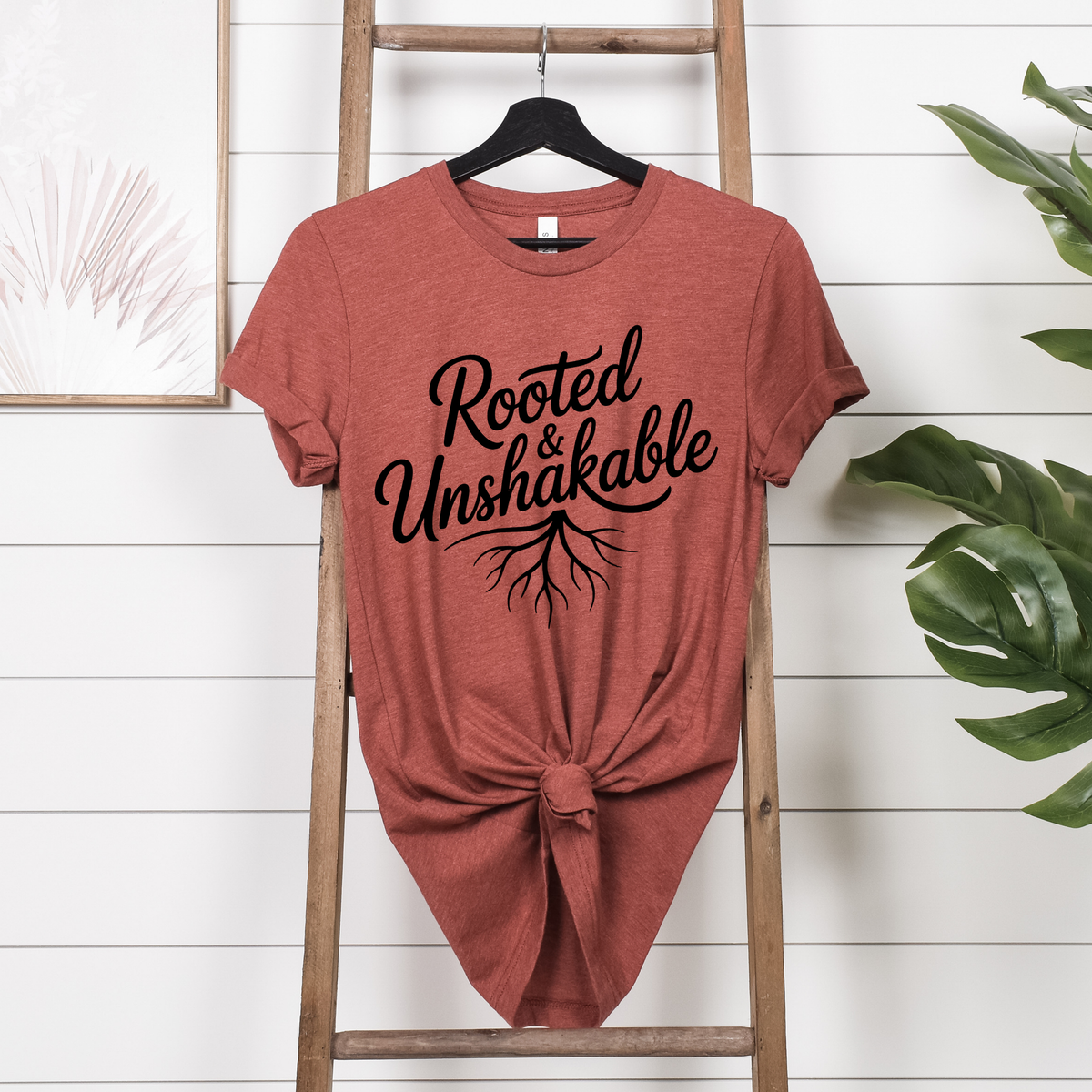 Faith tshirt for ladies in muted terracotta cotton with black Rooted & Unshakable lettering and root graphic