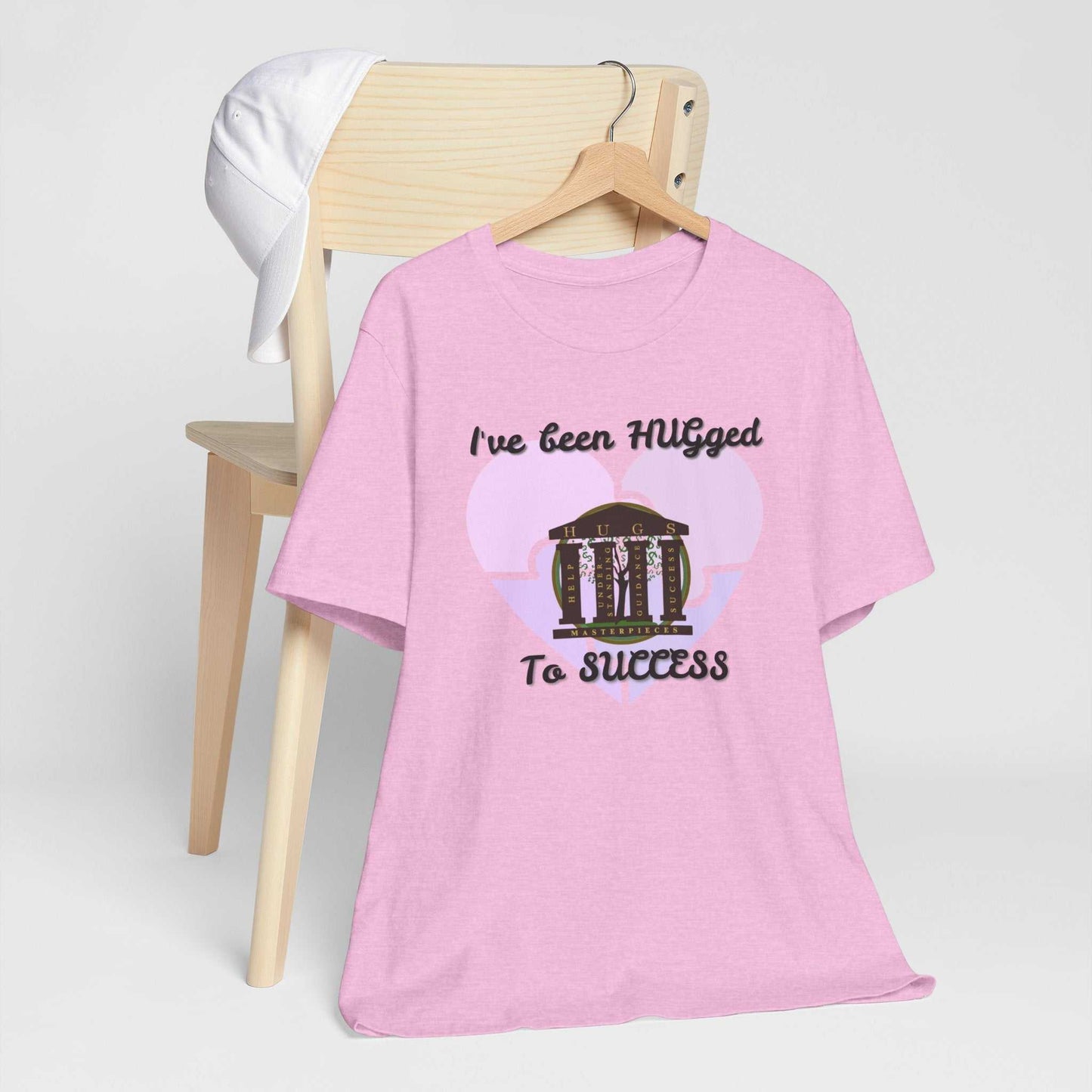 Lightweight pale blush Hugged To Success Tee with vintage storefront and pastel heart design on breathable cotton
