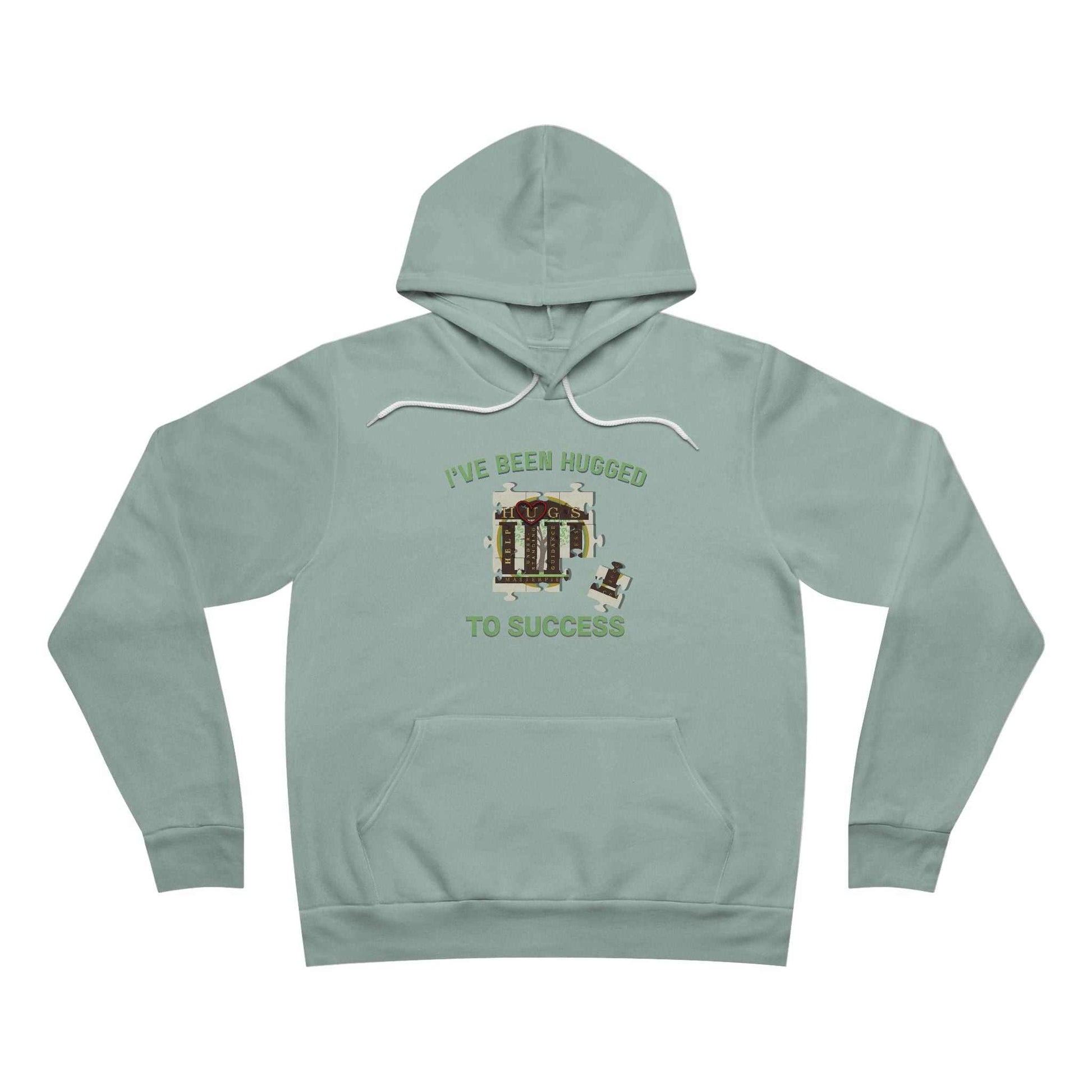 I've Been Hugged to Success Hoodie with puzzle-piece design, soft fleece interior, symbolizing growth and connection for HUGS graduates and affiliates