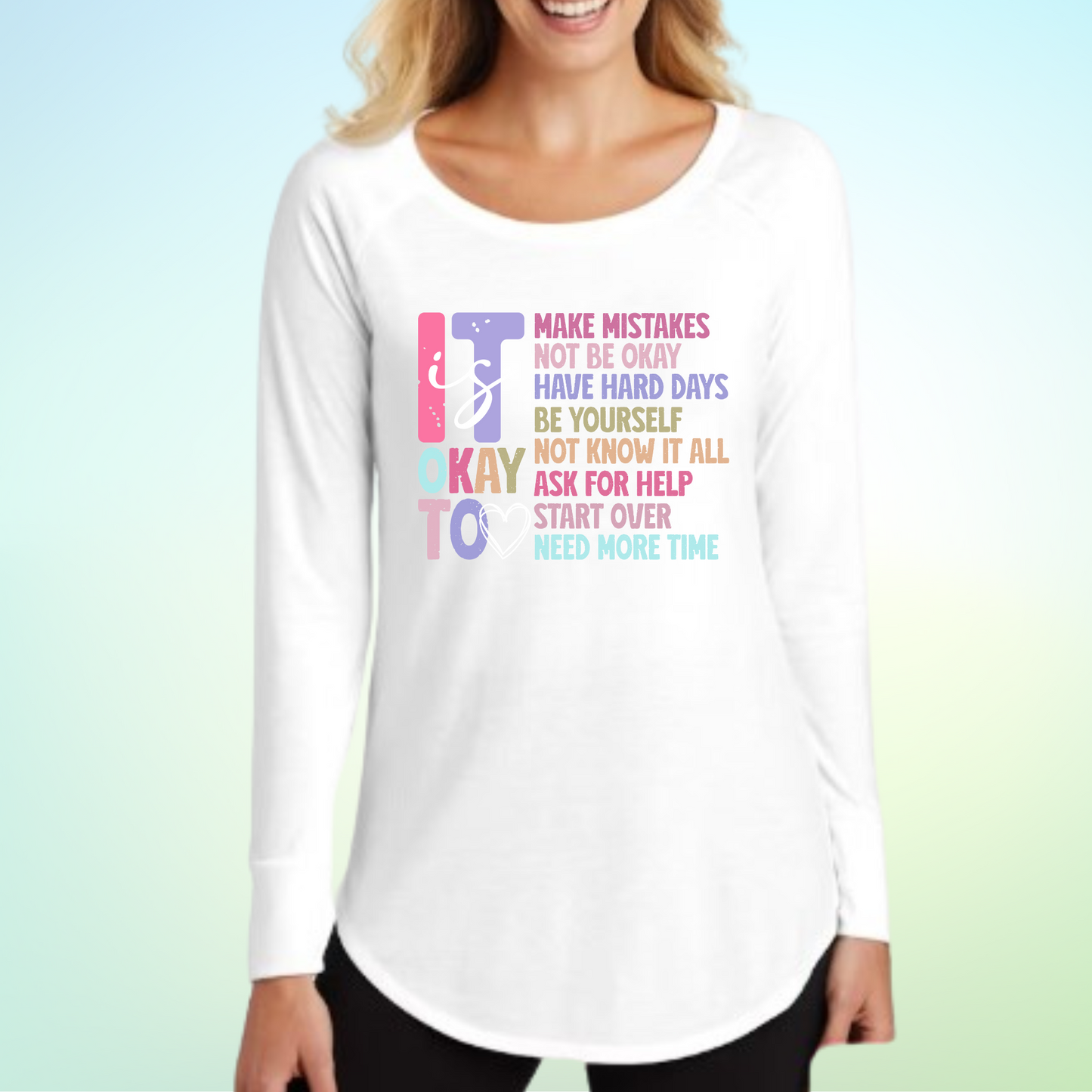 Woman wearing "It Is Ok To Make Mistakes" long sleeve shirt, white fabric.