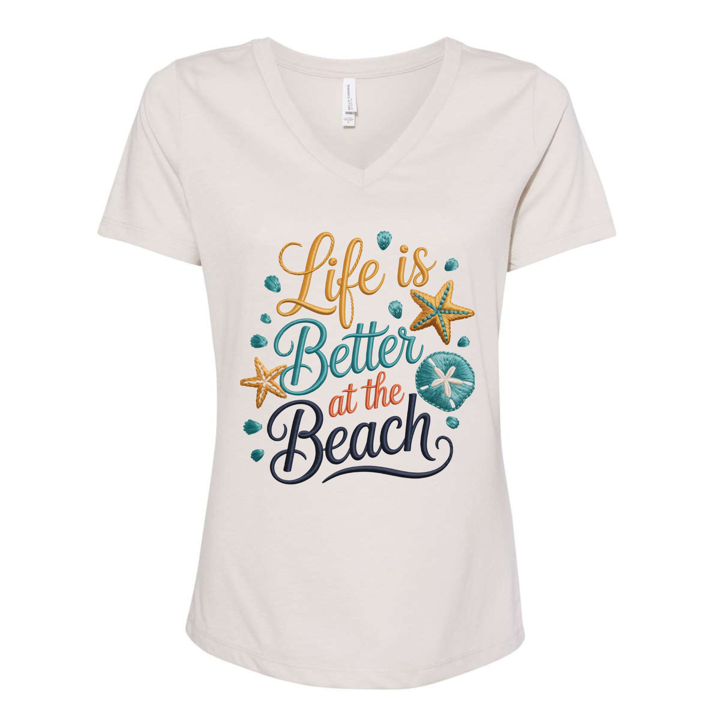 Women's V-neck tee with faux embroidered "Life Is Better at the Beach" cross-stitch design featuring seashells and starfish in coastal colors