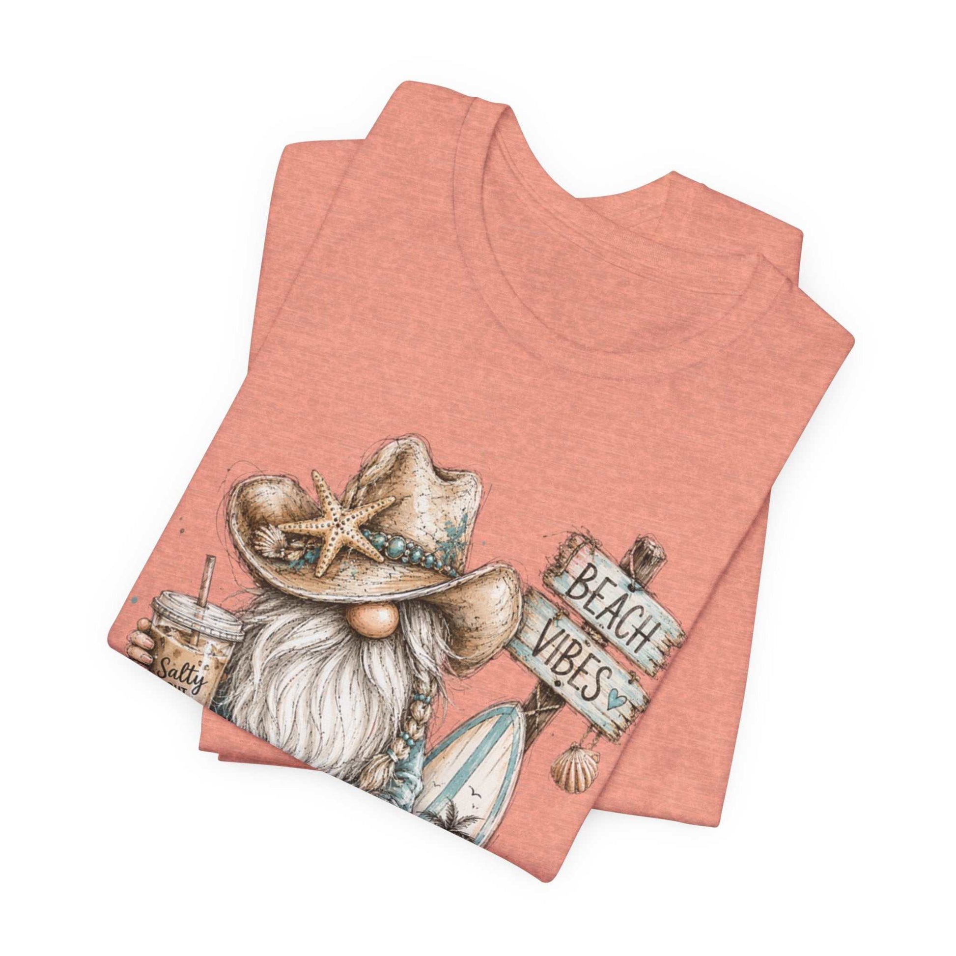 Coastal Cowgirl Beach Gnome watercolor tee with turquoise accents and cowboy boots on summer beach background