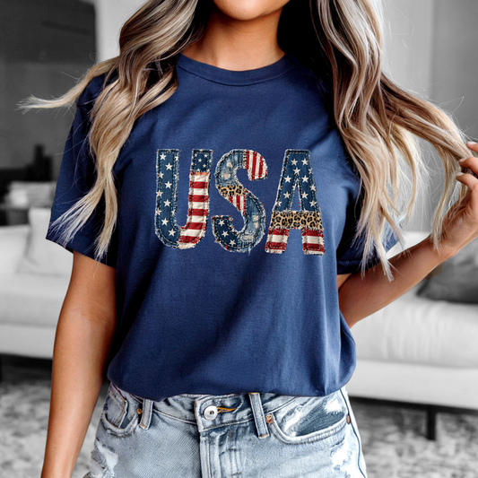 Patriotic Patchwork USA Tee with distressed denim, American flag, and leopard print accents in a vintage 3D patchwork design