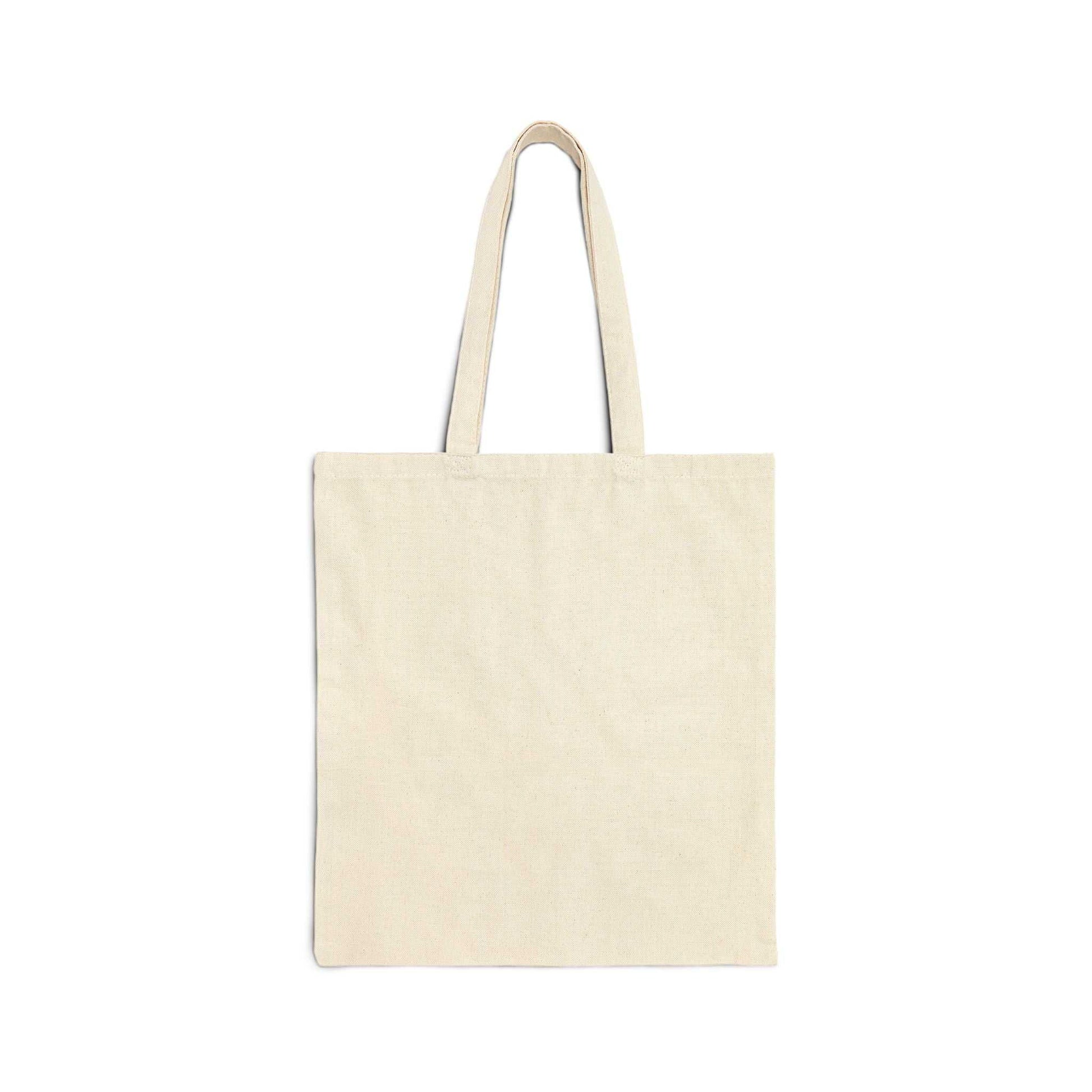 Durable cotton canvas tote bag with "I've Been Hugged to Success" print, featuring reinforced handles and flat-corner design in natural color