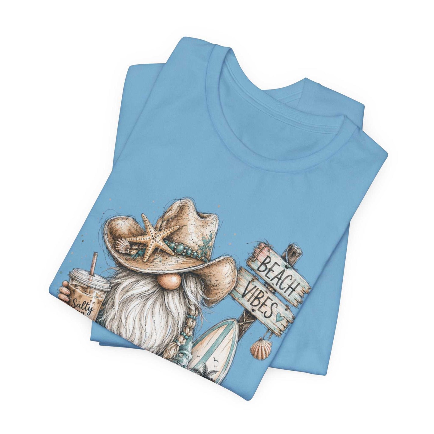Coastal Cowgirl Beach Gnome tee with turquoise accents, cowboy boots, seashells, and watercolor beach design