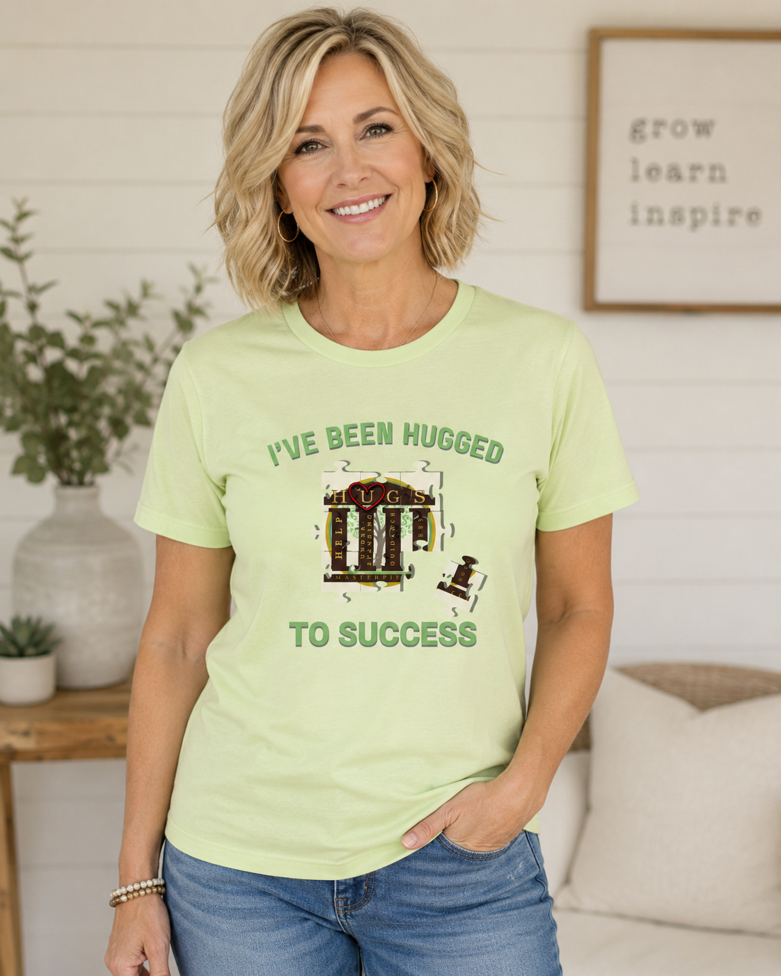 I've Been Hugged to Success tee with puzzle-piece design symbolizing growth and connection, soft Bella Canvas fabric, perfect for HUGS graduates and affiliates.