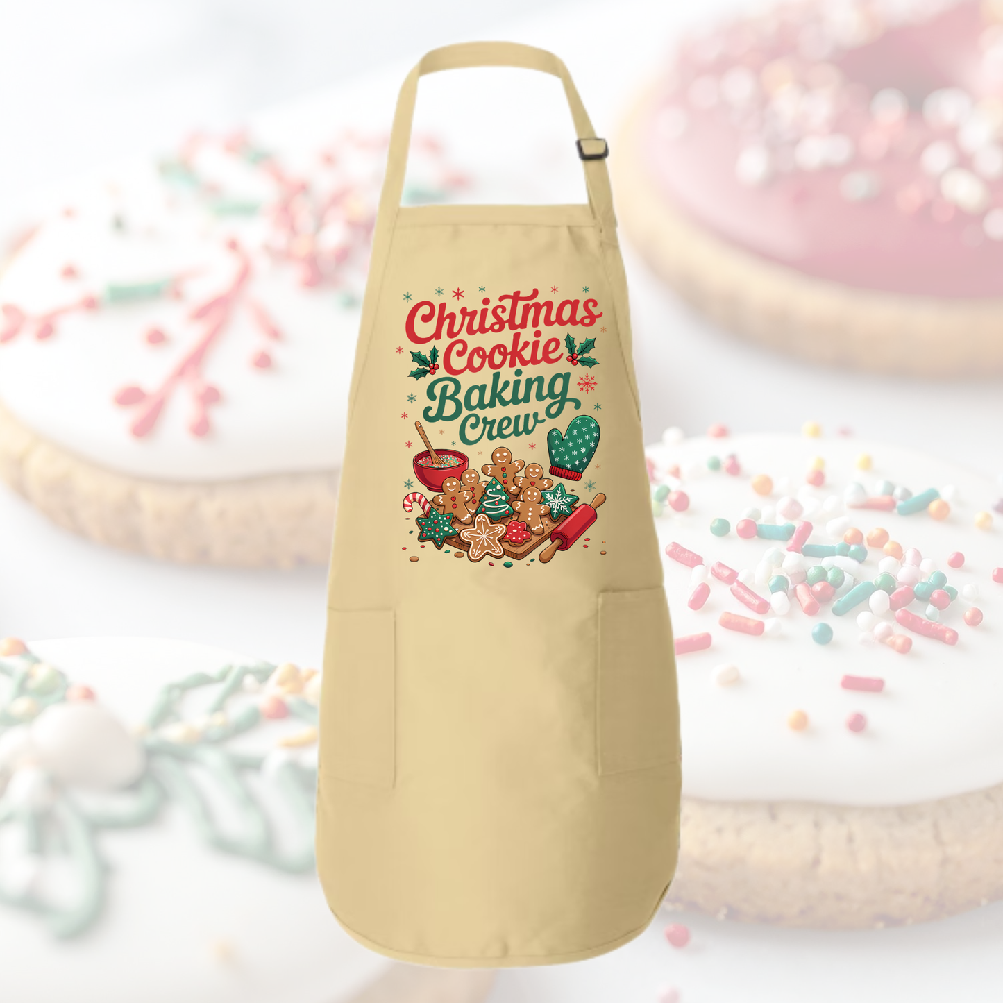 Beige apron with 'Christmas Cookie Baking Crew' design on a festive background with cookies and sprinkles.