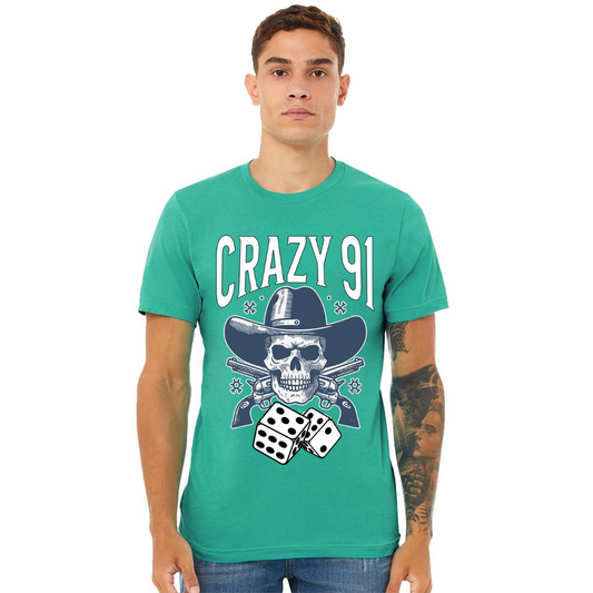 Man wearing vibrant teal Crazy 91 Tee with skull, guns, and dice graphic design