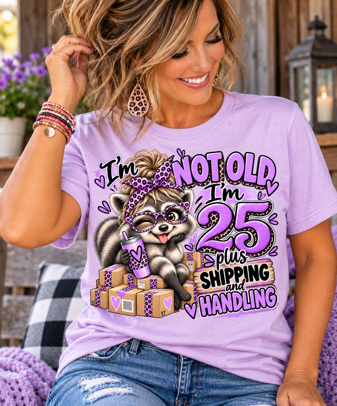 adult humor tshirt in lilac cotton with a playful raccoon, purple leopard-print bow, packages, and birthday slogan