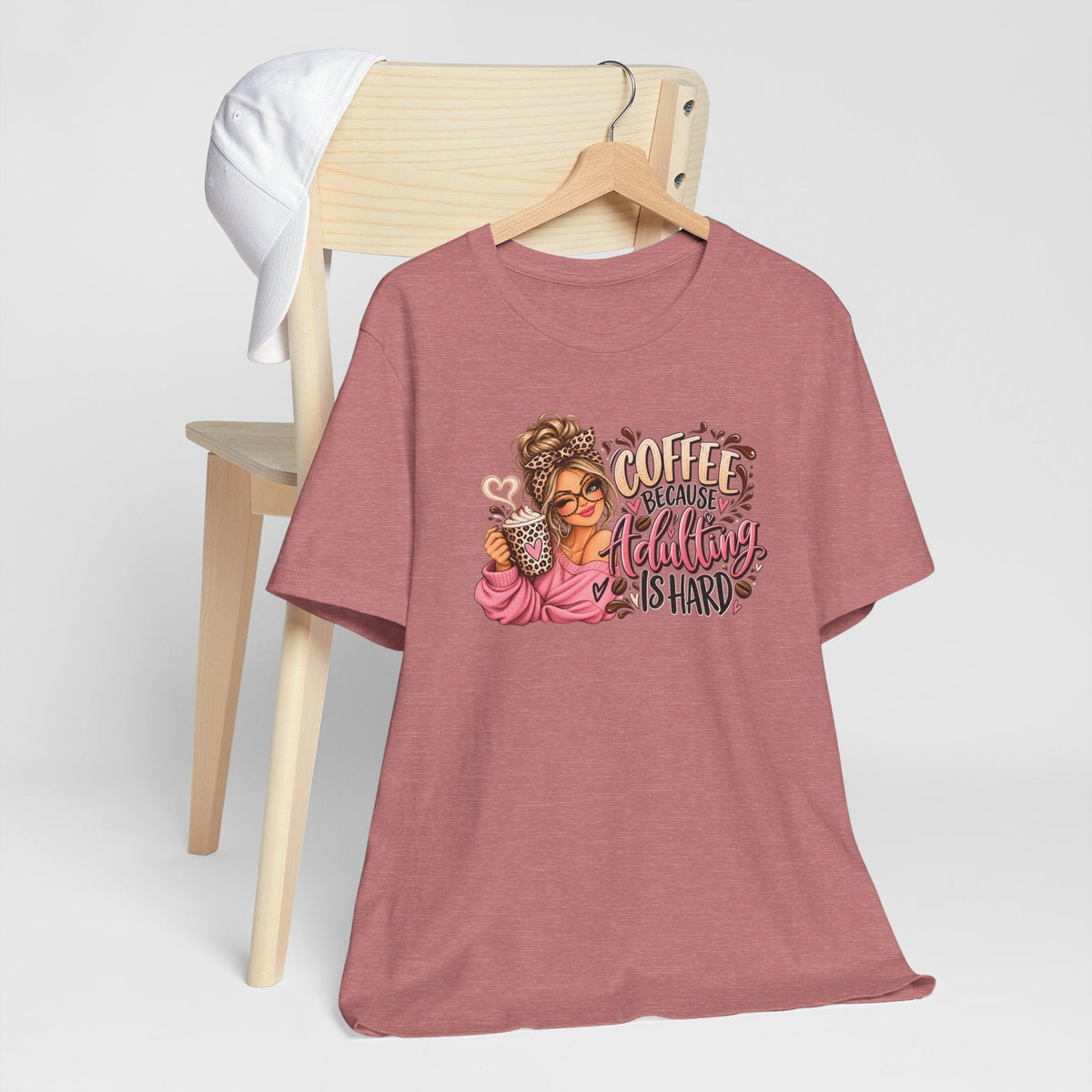 adulting tshirt in dusty rose with a colorful coffee-loving girl graphic, leopard accents, and playful lettering