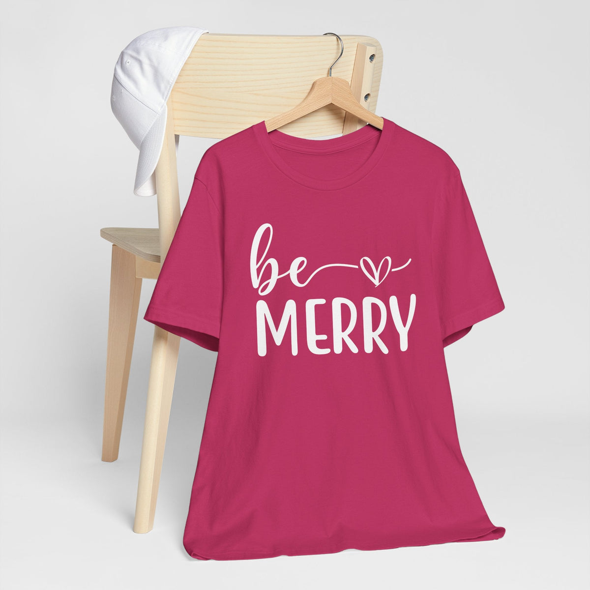 Be Merry Christmas Graphic Tee in berry cotton with white script and block lettering and a heart accent