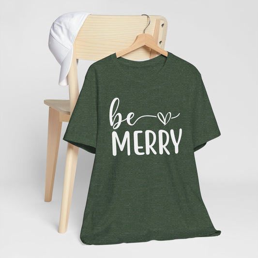 Be Merry Christmas Graphic Tee in dark green heathered fabric with white script and block lettering and a heart detail