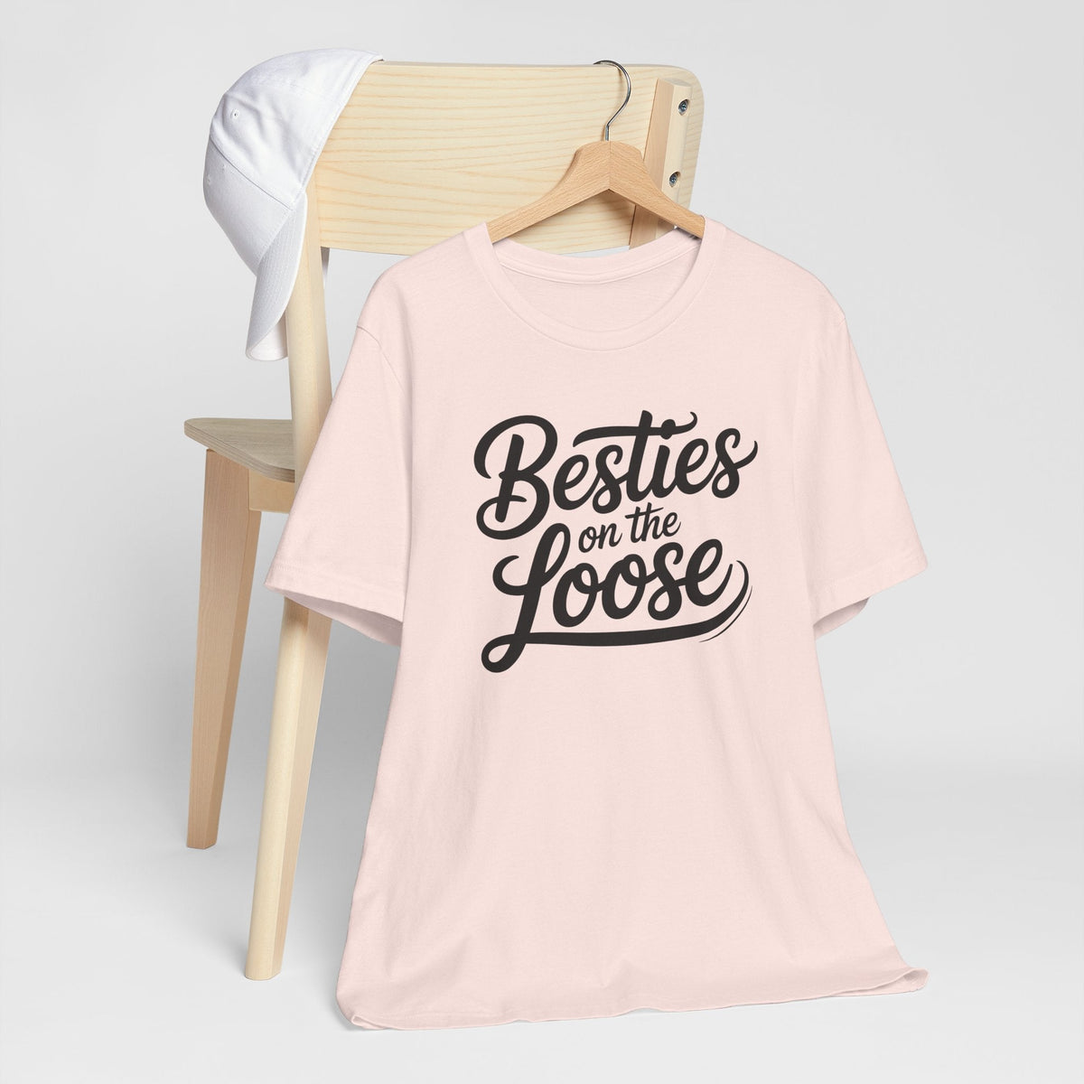 best friend funny tshirt in pale pink with short sleeves and bold black “Besties on the Loose” lettering