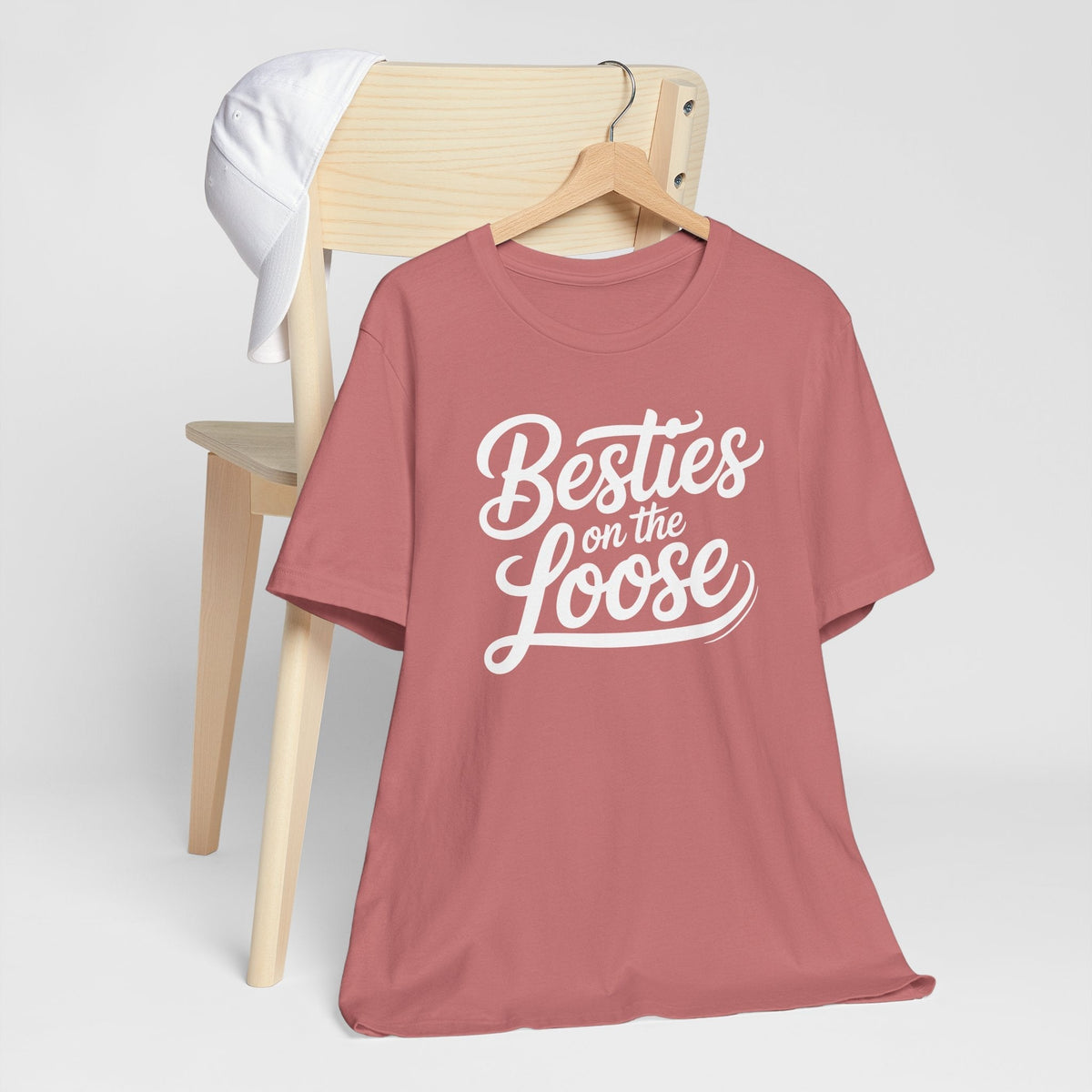 Pink best friend funny tshirt with short sleeves and white “Besties on the Loose” script graphic