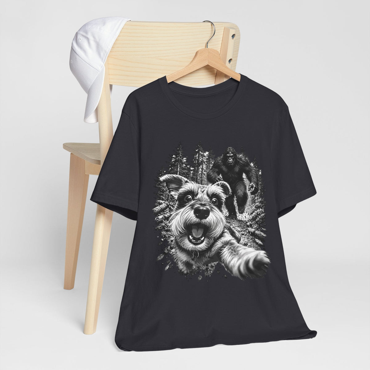 bigfoot shirt in black with a white graphic of an excited dog running through the woods with Bigfoot behind