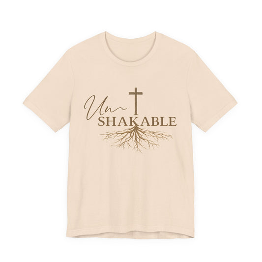 christian tshirts for women cream cotton T-shirt with brown Unshakable lettering, cross, and flowing root graphic
