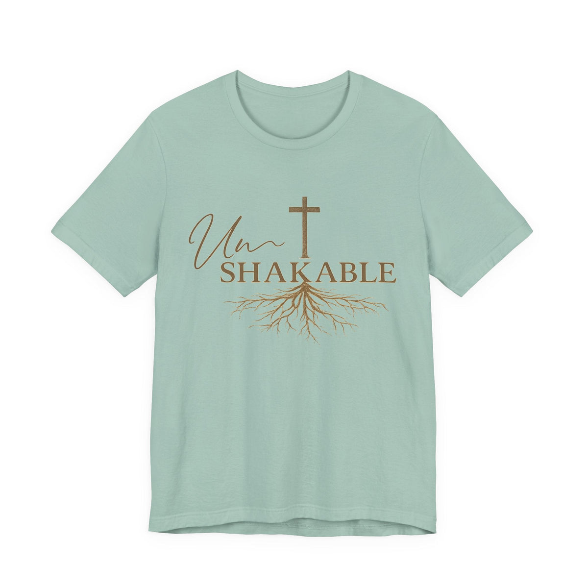 Christian tshirts for women: sage green cotton T-shirt with brown “Unshakable” lettering, a cross and flowing root design