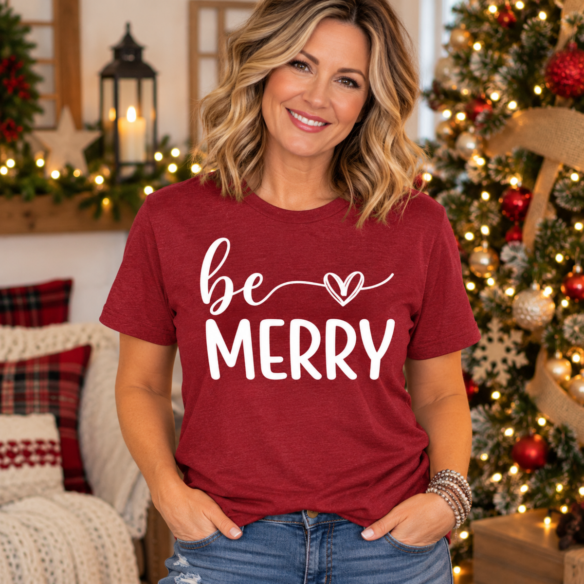 christmas graphic tee shirt in heather red with white “be MERRY” lettering, flowing script and a heart accent