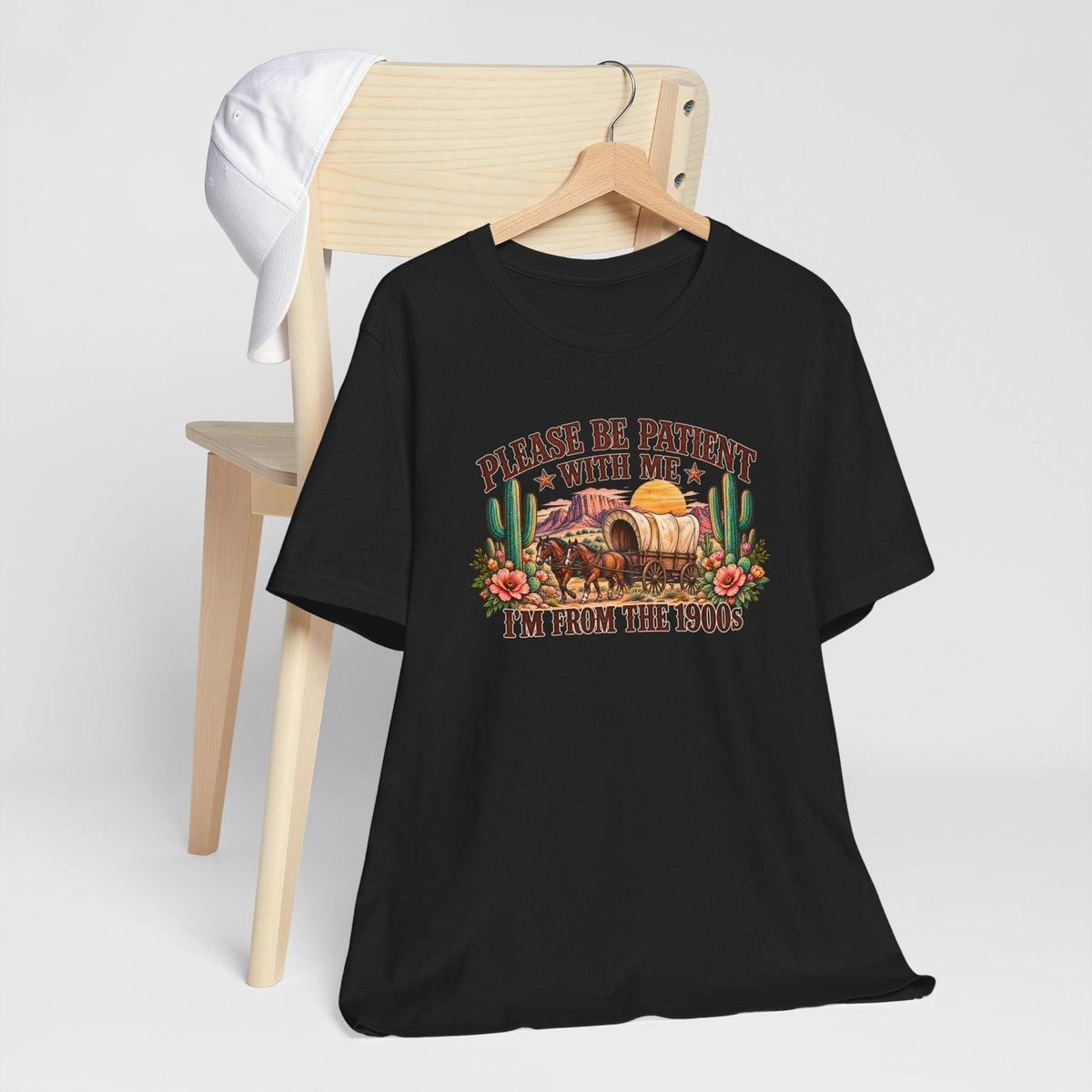cowgirl graphic tshirt in black cotton with a colorful vintage wagon, desert cacti, flowers and humorous text